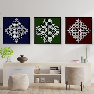 May include: Three framed prints with white geometric designs on different colored backgrounds. The prints are hanging on a white wall above a wooden shelf with books and decorative items.