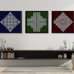 May include: Three framed square prints with white geometric designs on different colored backgrounds. The prints are hanging on a white wall above a black shelf with books and decorative objects.