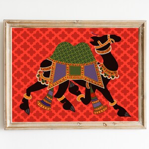 May include: A black camel silhouette with colorful decorations, including a green and purple saddle, on a red background with a repeating pattern.