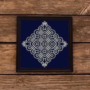 May include: A white geometric design on a dark blue background, framed in black. The design is a symmetrical pattern of circles and lines, creating a complex and intricate mandala-like shape.