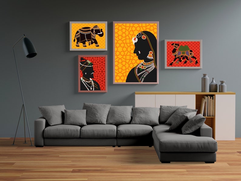 May include: Four framed illustrations of Indian cultural figures and animals. The illustrations are in a traditional style with black silhouettes on a colorful background. The frames are all the same size and shape, and they are arranged in a grid pattern on a gray wall.