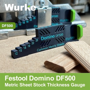 May include: Black and green Festool Domino DF500 metric sheet stock thickness gauge with markings for 12mm, 15mm, 18mm, 19mm, 22mm, and 25mm. The gauge is made of plastic and has a black and white striped pattern.