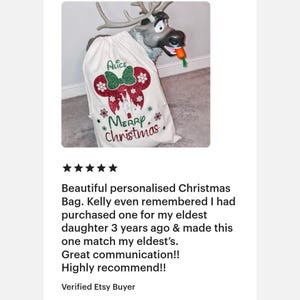 May include: A white Christmas stocking with a red and green glitter design featuring a Mickey Mouse head, the words "Alice" and "Merry Christmas", and a castle.