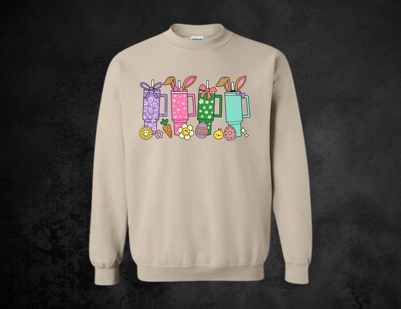 May include: A set of three ceramic mugs with a speckled, matte finish. The mugs are in shades of cream, light gray, and dark gray. Each mug has a simple, minimalist design, perfect for coffee or tea.