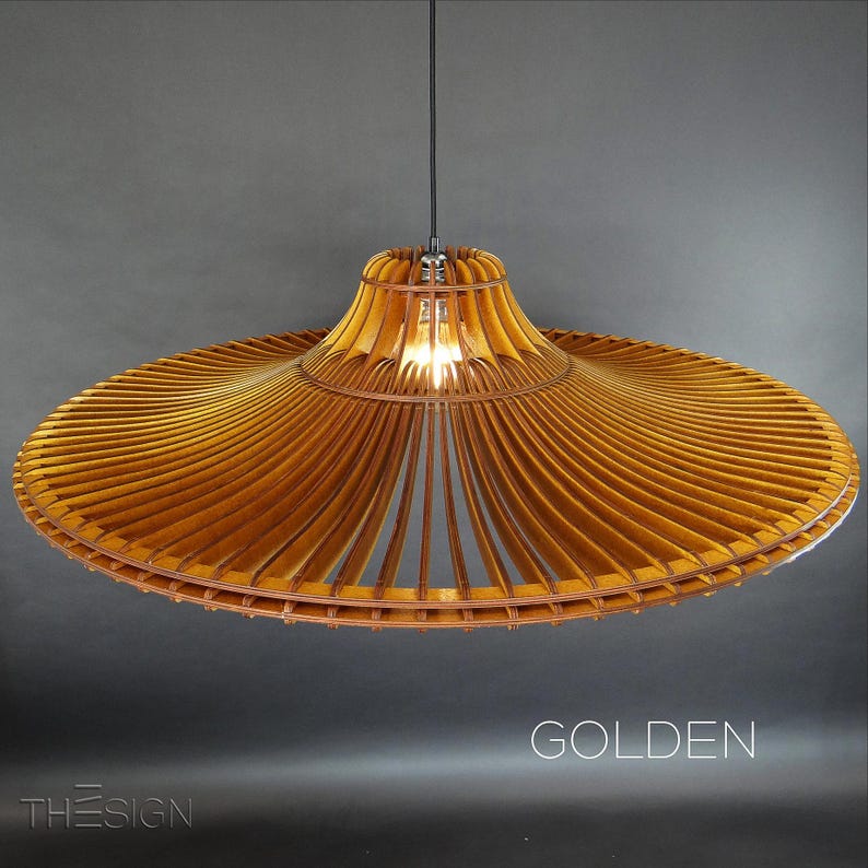 May include: A large, wooden, pendant light fixture with a wide, flat, circular shade. The shade is made of thin, wooden slats that are arranged in a radial pattern. The light fixture is suspended from a black cord and has a single light bulb.