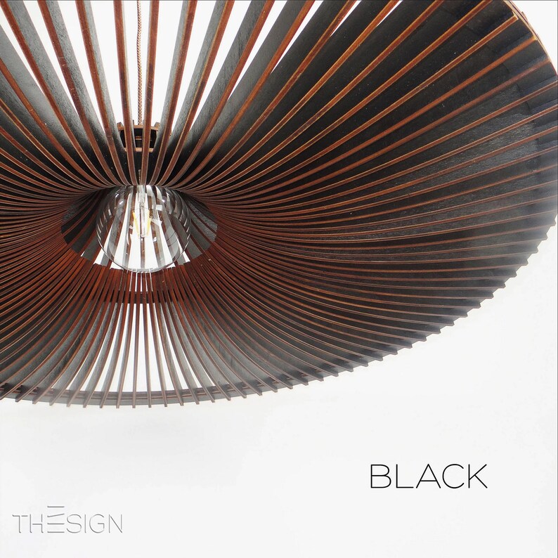 May include: A black, wooden, ceiling light fixture with a unique, spiral design. The light fixture is made of thin, wooden slats that are arranged in a spiral pattern. The light fixture is lit by a single light bulb.