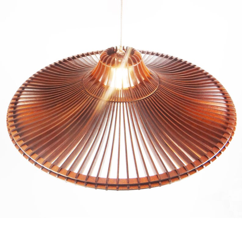 May include: A brown wooden pendant light fixture with a wide, flat, circular shade made of thin, radiating slats. The light fixture is suspended from a single cord.