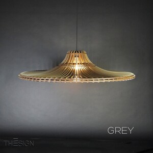 May include: A grey wooden pendant light with a wide, flat, circular shade. The shade is made of thin, slatted wood and has a slightly curved, conical shape.
