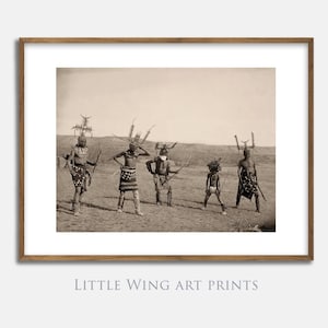 May include: Sepia-toned framed print showing a group of Native American dancers in traditional dress, holding weapons. The print is labelled "Little Wing Art Prints" and "Vintage and Decorative Printable Art".