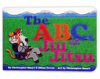 May include: A colorful book cover with the title "The ABCs of Jiu Jitsu" in large, colorful letters. The cover features a cartoon illustration of a cat and a dog in a jiu jitsu pose on a green background.