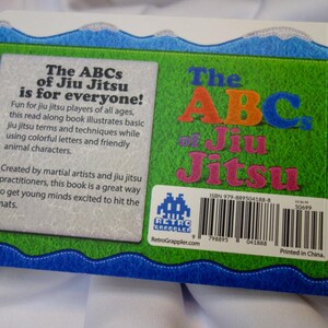 May include: The back cover of a children's book titled "The ABCs of Jiu Jitsu is for everyone!"  The book cover is green with a blue wave border. The book cover features a colorful illustration of the letters ABC and the words "Jiu Jitsu". The book cover also includes an ISBN number, a barcode, and the text "Printed in China."