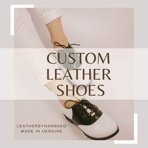 K&ouml;nnte beinhalten: Ma&szlig;gefertigte Lederschuhe in Schwarz und Wei&szlig;, mit klassischem Oxford-Design. Die Schuhe haben schwarze Schn&uuml;rsenkel und eine perforierte Zehenkappe. Der Text "CUSTOM LEATHER SHOES" ist in brauner Schrift dargestellt. Die Marke ist "LEATHERBYHANNAKO".