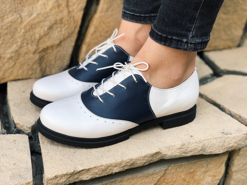 Saddle Shoes History- Women’s and Men’s Leather shoes Womens White Oxford Flats Saddle shoes Comfortable Wear Lace up Oxford Hand Made Sole Custom Wide Oxford $126.00 AT vintagedancer.com