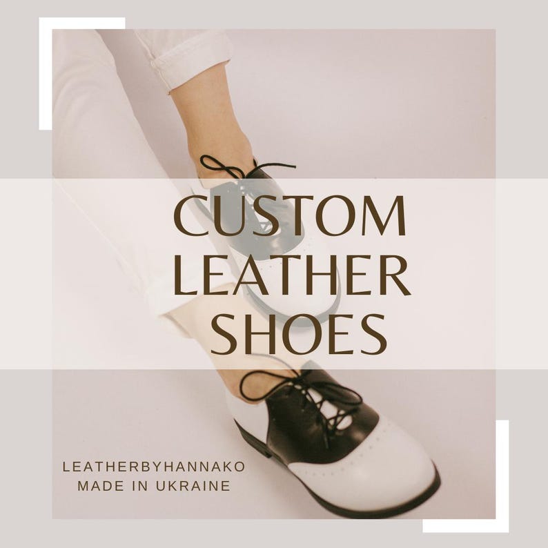 May include: Custom leather shoes in a two-tone design, black and white, with black laces. The image features the text "CUSTOM LEATHER SHOES" and the brand name "LEATHERBYHANNAKO MADE IN UKRAINE".