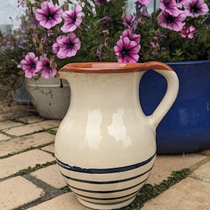 Ceramic wine or water jug. Ceramic pitcher with blue stripes.