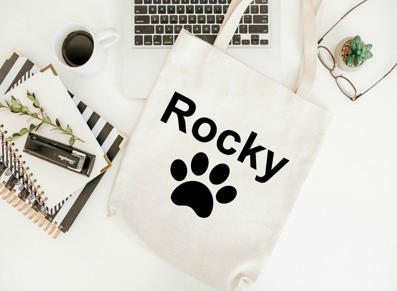 Let the world know you are an animal lover with the name of your special pet on a tote with paw designs use as a grocery tote or book bag