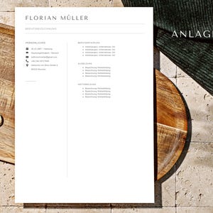 以下が含まれることがあります： 「FLORIAN M&Uuml;LLER」と記載された白い履歴書。履歴書には、連絡先、職務経歴、学歴など、個人情報と職務に関する情報が記載されている。ページの右上には「ANLAGAN」という単語が書かれている。