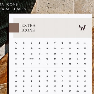 May include: A white sheet with the text "EXTRA ICONS" and a collection of small, black icons. The icons include social media logos, symbols, and other graphic elements. The sheet is on a wooden surface.