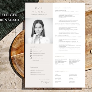 May include: A black and white resume with the name Eva Vogel, Personalreferent, at the top. The resume lists her work experience, education, and qualifications. The resume is on a wooden surface.