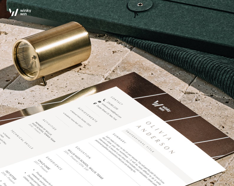 May include: A gold-colored cylindrical object with a clock face is next to a resume. The resume is white with brown accents and the name "Olivia Anderson" at the top. The resume also has the "winky win" logo. A dark green case is in the background.
