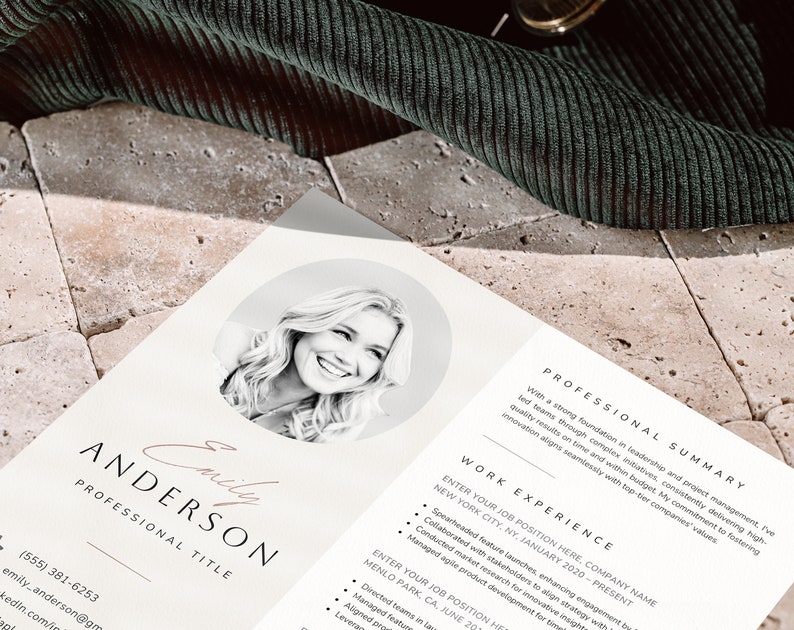 May include: A black and white photo of a woman smiling. The photo is in a circle on a white resume with the text "Emily Anderson" and "Professional Title" in a black font. The resume also includes a professional summary and work experience section.
