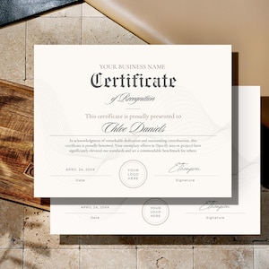 May include: Two certificates of recognition with elegant script and a wave design. The certificates include fields for a business name, recipient's name, date, logo, and signature. The text reads "Certificate of Recognition".