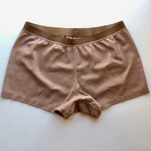 May include: A pair of brown shorts with a brown elastic waistband.