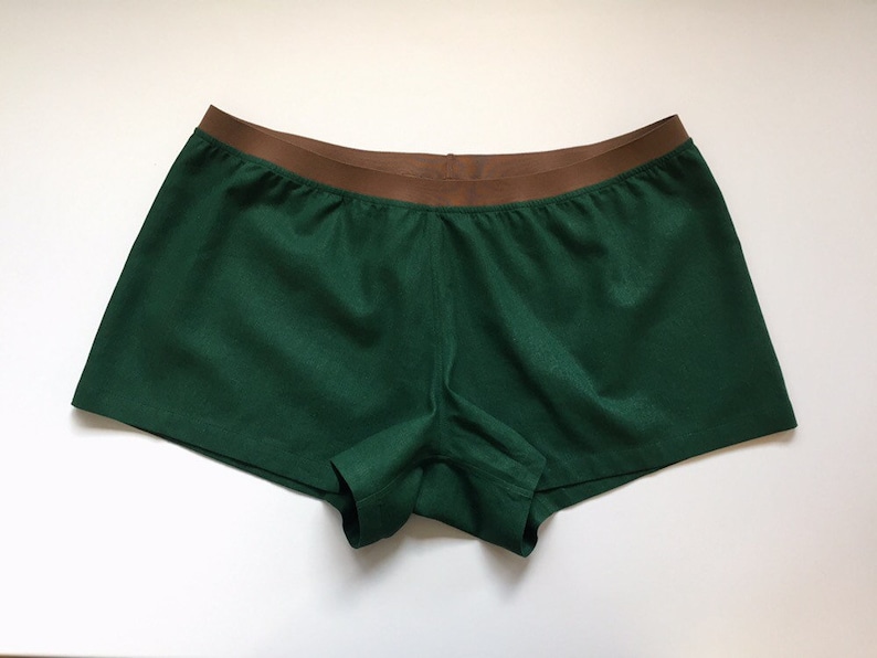 May include: Green and brown shorts with a wide elastic waistband.