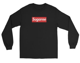 May include: Black long-sleeve shirt with the word "Sugaree" in white text inside a red rectangular box on the chest. The shirt has a crew neck and long sleeves.