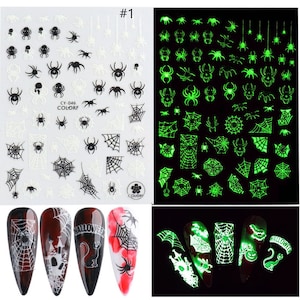 May include: Set of two sheets of glow-in-the-dark nail stickers featuring spiderwebs and spiders. The stickers are white and green. The stickers are shown on a set of four nails with a Halloween theme.
