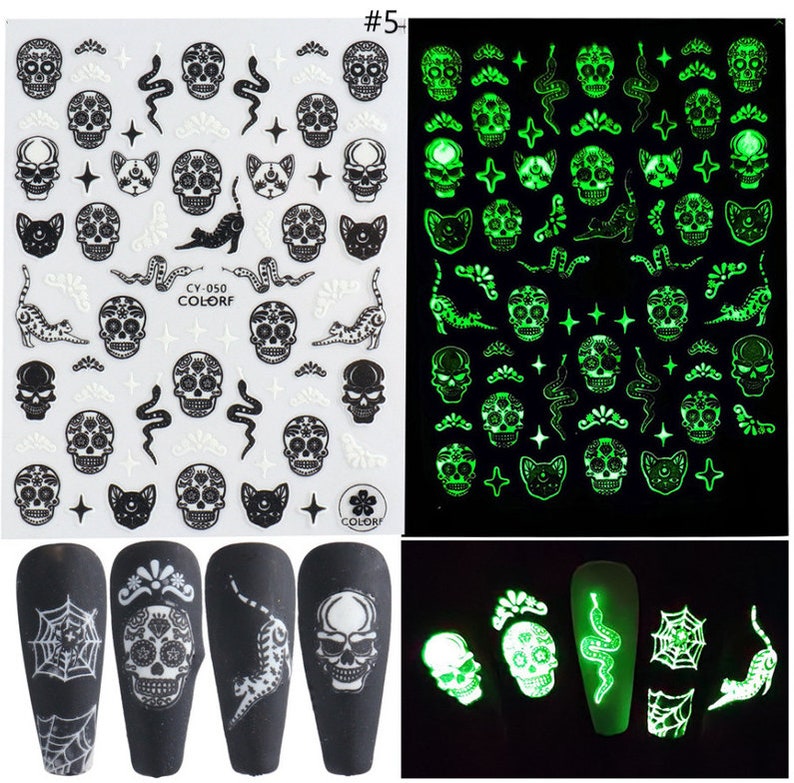 May include: A sheet of glow-in-the-dark nail stickers with a variety of designs, including skulls, cats, snakes, and stars. The stickers are on a white background and are ready to be applied to nails. #5+
