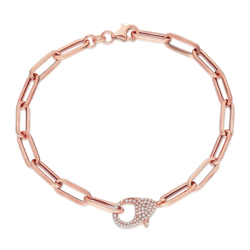 May include: A rose gold chain bracelet with a pave diamond clasp. The chain is made of oval links.
