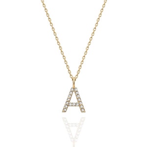 May include: A gold chain necklace with a diamond-encrusted letter A pendant.