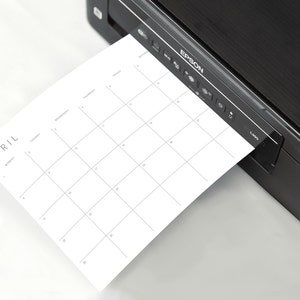 Effortless monthly planning with our printable planner, illustrated by the planner being printed from a modern printer.