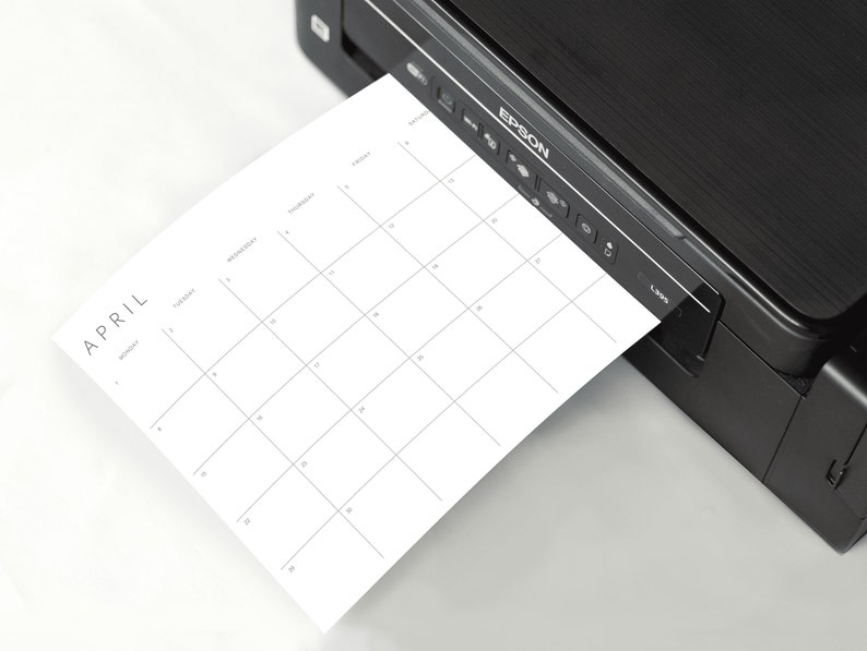 Effortless monthly planning with our printable planner, illustrated by the planner being printed from a modern printer.