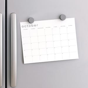 June 2026 printable monthly sheet laid flat on a light neutral background. Horizontal design shows seven weekday columns, clear black dates, and pale linework across A4 white paper.