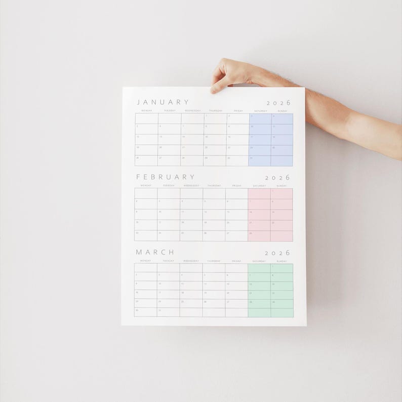 May include: A 2026 wall calendar featuring the months of January, February, and March. Each month is displayed in a grid format with black text on a white background. The weekend columns are highlighted in light blue, light pink, and light green.