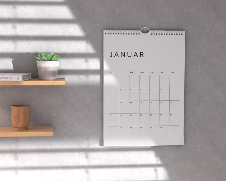 Minimalistischer deutscher Kalender 2026 auf weißem Papier, ein Monatsblatt im Hochformat A4, klare Linien und moderne Typografie, liegt auf hellem neutralem Hintergrund, druckbare PDF-Vorlage.