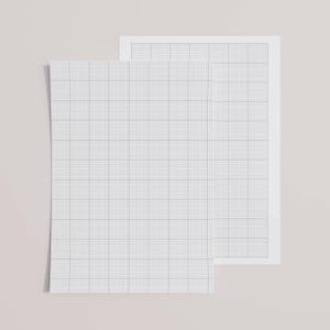 A printed letter-size sheet with ten by ten grid lines, resting on a wooden table, photographed under daylight to highlight the fine line pattern and smooth paper texture.
