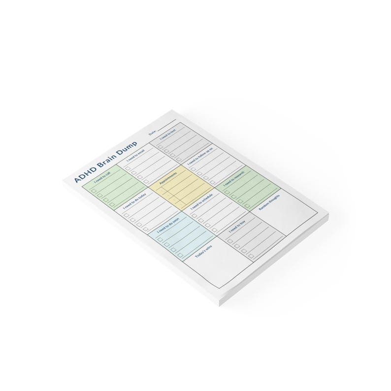 Physical sticky note pad with ADHD daily checklist design placed on a clean desk, showing sections for calls, research, brain dump, appointments, and daily task planning.
