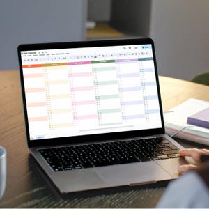 Workspace setup with laptop and monitor displaying 2026 Excel and Google Sheets planners in a modern digital workspace