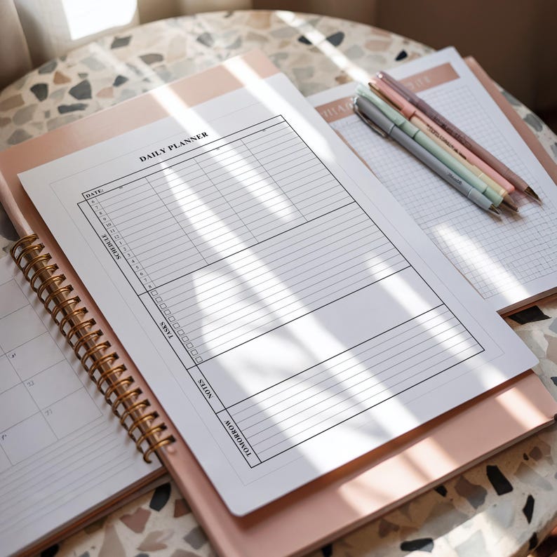Flat lay of a printable daily planner page, showcasing minimalist sections for scheduling, task management, and notes.