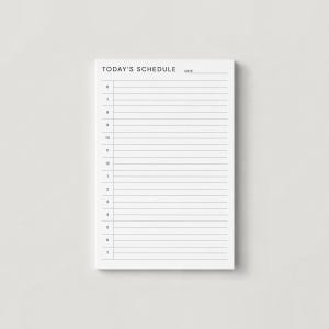 May include: A white notepad with the text "TODAY'S SCHEDULE" at the top, followed by a date line and a schedule grid with hourly time slots from 6 AM to 7 PM. The notepad is rectangular.