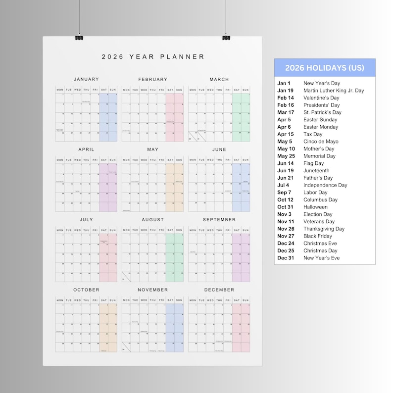 May include: A 2026 year planner poster with a grid layout, featuring monthly calendars with highlighted dates. A list of 2026 US holidays is displayed on the right. The calendar is designed for easy planning and organization.