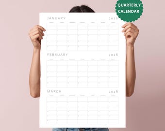 May include: A white paper quarterly calendar for 2026 featuring grids for January, February, and March. The calendar has thin black lines and minimalist typography. A green scalloped circular badge in the top right corner reads QUARTERLY CALENDAR.