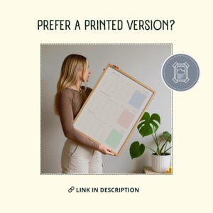 May include: A framed calendar with a wooden frame is held by a person. The calendar displays the months of January, February, and March, each with a colored box. The text "PREFER A PRINTED VERSION?" and "LINK IN DESCRIPTION" are also visible.