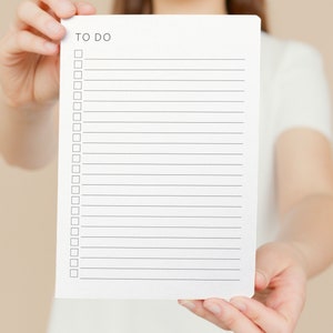 May include: A white sheet of paper with the words "TO DO" at the top and a list of empty checkboxes.