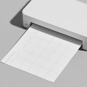 Minimalist 2027 monthly planner page printing from a home printer, showing the instant printable PDF format.