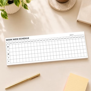 May include: A white work week schedule notepad with a grid layout, featuring the text "WORK WEEK SCHEDULE" and time slots from 6:00 AM to 6:00 PM. A gold pen and sticky notes are also visible.