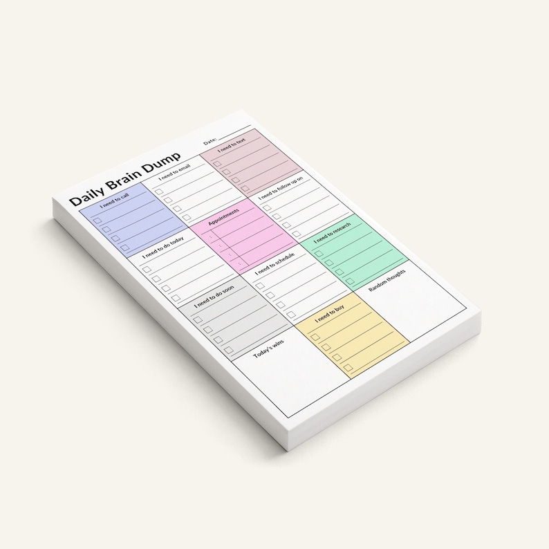 4x6 ADHD planner pad placed on a notebook, showing structured layout with shaded sections for tasks, calls, appointments, and brain dump, compact adhesive sheets for focus and productivity.